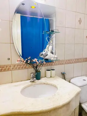 a bathroom with a sink and a mirror at Seaview in Malate in Manila