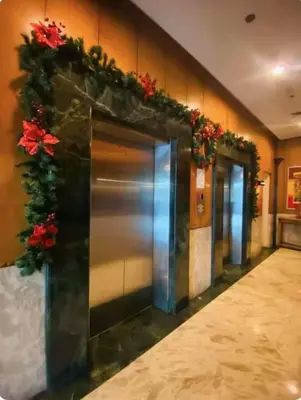 an elevator in a building with flowers on the wall at Seaview unit in Manila