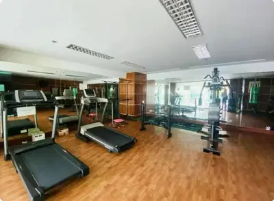 a gym with several treadmills and exercise equipment at Seaview unit in Manila
