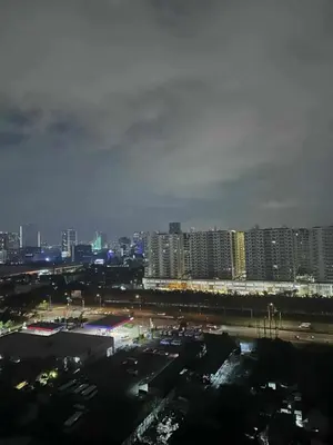a view of a city at night with tall buildings at Shore 2 tower 2 in Manila