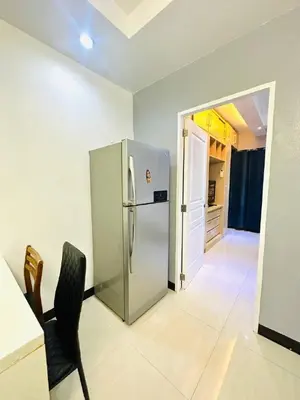 a kitchen with a stainless steel refrigerator in a room at 1 Bedroom Seaview Room Korean Town heart of malate in Manila