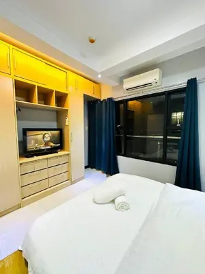 a room with a bed and a tv in it at 1 Bedroom Seaview Room Korean Town heart of malate in Manila