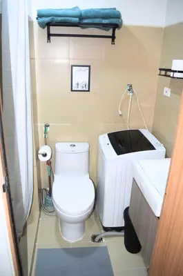 a small bathroom with a toilet and a sink at Shore Staycation at Shore 3 Mall of Asia in Manila