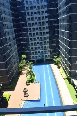 an overhead view of a swimming pool with tall buildings at Shore Staycation at Shore 3 Mall of Asia in Manila