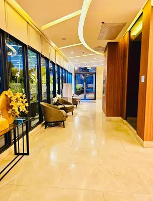 a lobby with chairs and tables in a building at The Destination in Manila