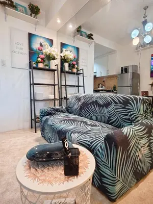 a living room with a couch and a table at Staycationsite at Sea Residences in Manila