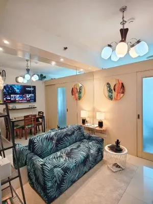 a living room with a couch and a table at Staycationsite at Sea Residences in Manila