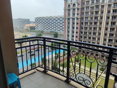 a balcony with a view of a pool and buildings at WS906 Condo near Moa, Free Pool Access in Manila