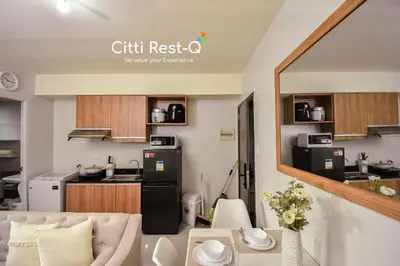 a living room and kitchen in a small apartment at Stylish Condo with Free Wifi & Netflix, Near Airport HMS3 in Manila