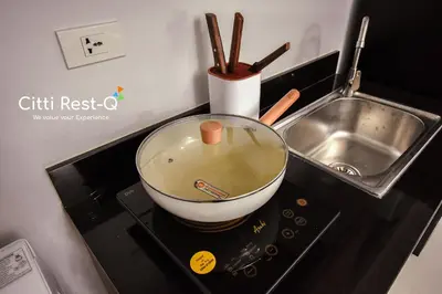 a kitchen counter with a bowl on top of a stove at Stylish Condo with Free Wifi & Netflix, Near Airport HMS3 in Manila