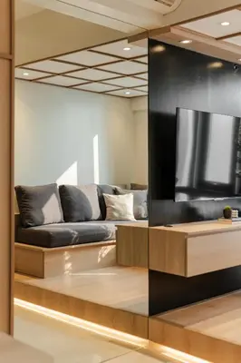 a living room with a couch and a flat screen tv at Eastwood City 1BR Muji Home Luxe Minimalist Fast WiFi in Manila