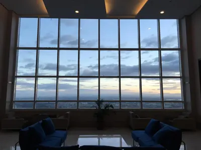 a large window in a room with couches and a table at Studio Unit at The Beacon Makati in Manila