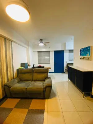 a living room with a couch and a table at Torre De Manila taft Tan38 in Manila
