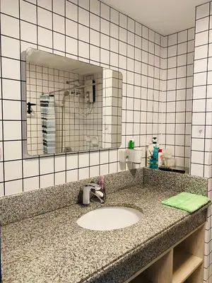 a bathroom counter with a sink and a mirror at Torre De Manila taft Tan38 in Manila