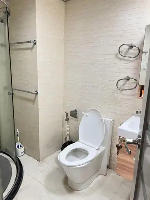 a bathroom with a toilet and a sink at R&R Empire Rental Unit in Manila