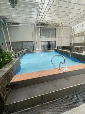a large swimming pool in a building at Makati City Antel Spa Residences 2306 in Manila