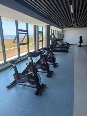 a row of exercise bikes in a gym with windows at Sy bay in Manila