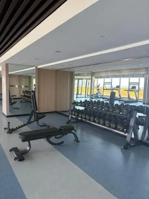 a gym with rows of exercise equipment in a building at Sy bay in Manila
