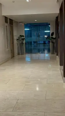 a hallway with two potted plants in a building at Casa De Ciudad - Shore Residences MOA PASAY in Manila