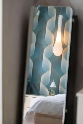 a room with a bed with a blue and white wall at SM Bicutan Condotels Felis in Manila