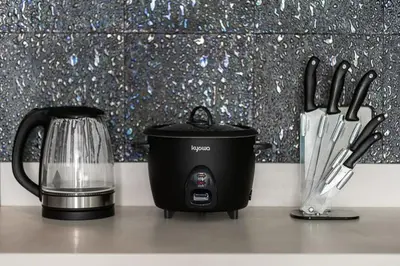 a toaster and a blender on a counter with knives at SM Bicutan Condotels Felis in Manila