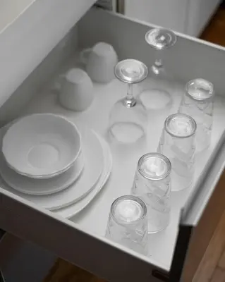 a table with plates and glasses and plates at SM Bicutan Condotels Felis in Manila