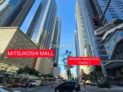 a busy city street with tall buildings and street signs at Prime 1BR Condo in the Heart of BGC #upt12j in Manila