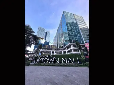 a sign in front of a tall building at Prime Uptown BGC | Stylish 1BR Getaway #upt1 35j in Manila