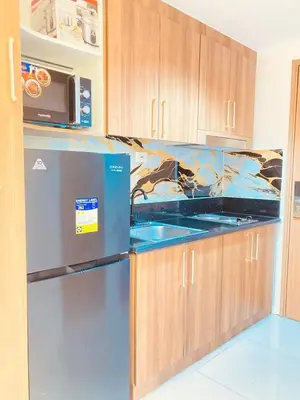 a kitchen with a refrigerator and a microwave at Casa Cion Staycation in Manila