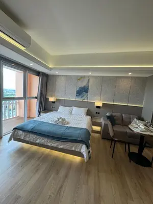 a bedroom with a large bed and a couch at Venice Luxe Stay, Studio Type, King Bed, 65 TV-Netflix 40\u5e73\u65b9\u56db\u4eba\u516c\u5bd3 \u53a8\u5177\u9f50\u5168 in Manila