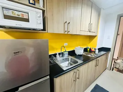 a kitchen with a sink and a microwave at Mango Room near MOA STARCITY 2 Beds in Manila