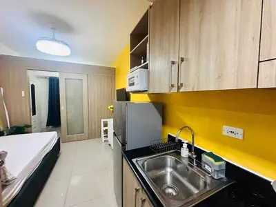 a kitchen with a sink and a refrigerator at Mango Room near MOA STARCITY 2 Beds in Manila