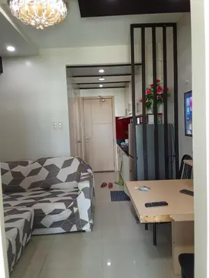 a living room with a couch and a table at Sea Residences david in Manila