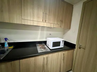 a microwave sitting on a counter in a kitchen at Shore residences A 1br Near SM MOA in Manila