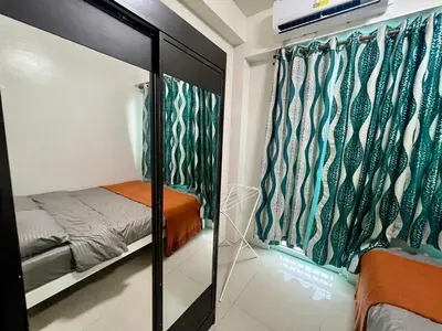 a bedroom with a bed and a mirror at Shore residences A 1br Near SM MOA in Manila