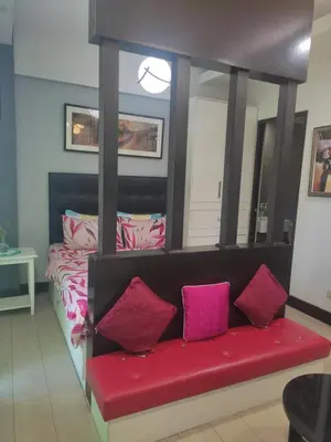 a room with a red couch with a mirror at LDN Staycation Booking partners in Manila