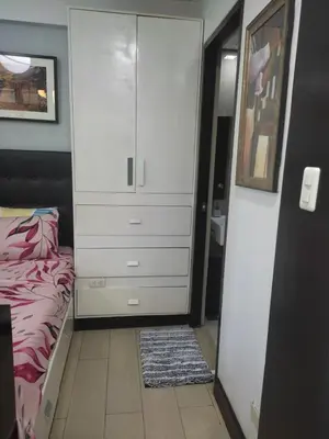 a bedroom with a bed and a dresser at LDN Staycation Booking partners in Manila