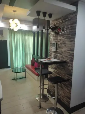 a living room with a bar and a brick wall at LDN Staycation Booking partners in Manila