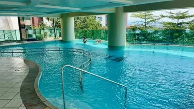 a large pool with blue water in a building at Whole Ocean View Manila Bay 4 Bedrooms in Manila