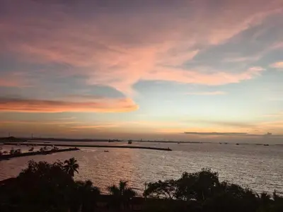 a sunset over a large body of water at Whole Ocean View Manila Bay 4 Bedrooms in Manila