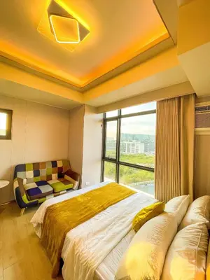 a bedroom with a large bed and a window at Modern & Luxury 1BR near Okada, Solaire, Airport in Manila