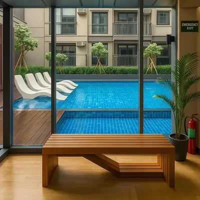 a swimming pool with a bench in front of a building at Modern & Cozy 2BR near Okada, Solaire, Airport in Manila