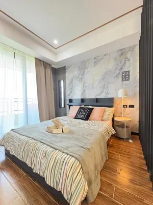 a bedroom with a large bed with a large wall at Sybaysuites staycation near Okada COD MOA NAIA airport Solaire MSV1808H in Manila