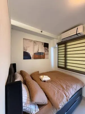a bedroom with a large bed in a room at ElcaPri Staycation - Shore 2 Residences in Manila