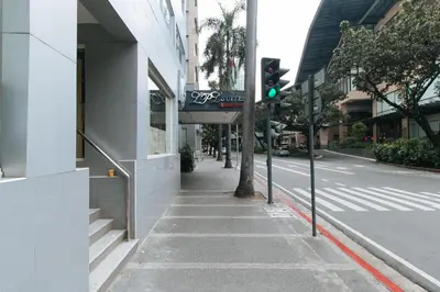 a street with a green traffic light on a sidewalk at Greenbelt Makati - Vaccinated Staff in Manila