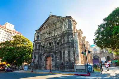 an old stone building on the corner of a street at Super OYO Capital O 232 Nest Nano Suites Fort in Manila