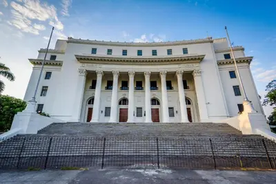 a white building with stairs in front of it at OYO 766 Ichehan Apartments in Manila