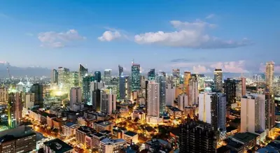 a large city at night with a lot of buildings at City Stay Inns Slex Makati in Manila