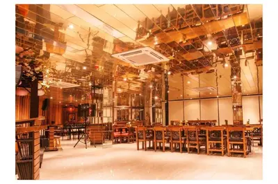 a large room with wooden tables and chairs at Capital O 897 Takara Hotel And Events Place in Calamba