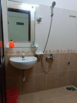 a bathroom with a sink and a mirror at Capital O 897 Takara Hotel And Events Place in Calamba